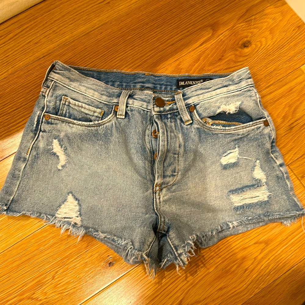 Light washed ripped denim shorts in size 25.